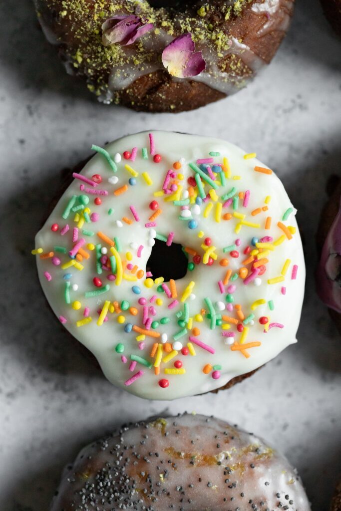 a funfetti old fashioned donut photographed from above