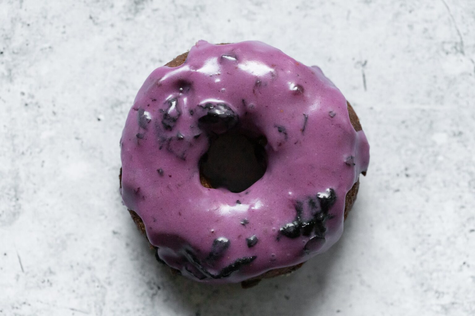 a blueberry old fashioned donut photographed from above