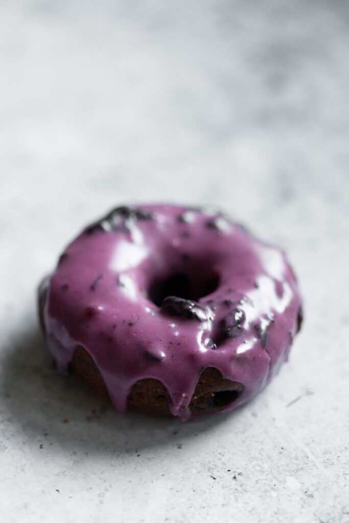 a blueberry old fashioned donut photographed from the side