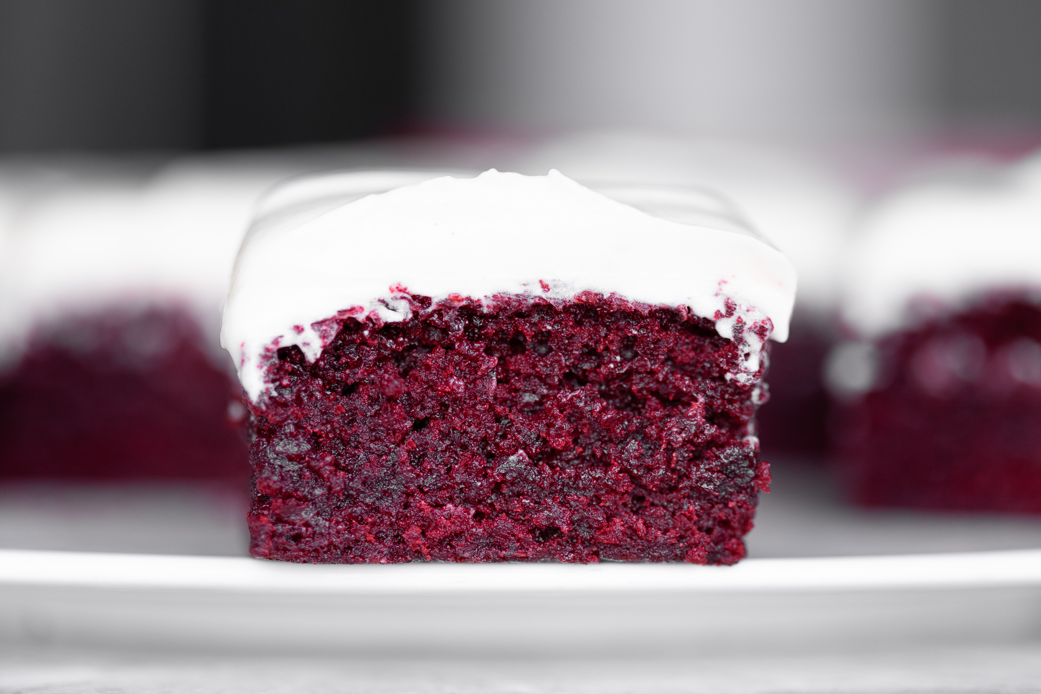 a sliced red velvet brownie with swooped frosting, photographed straight-on