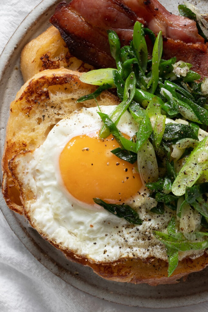 savory French toast with a sunny-side-up egg and green onions