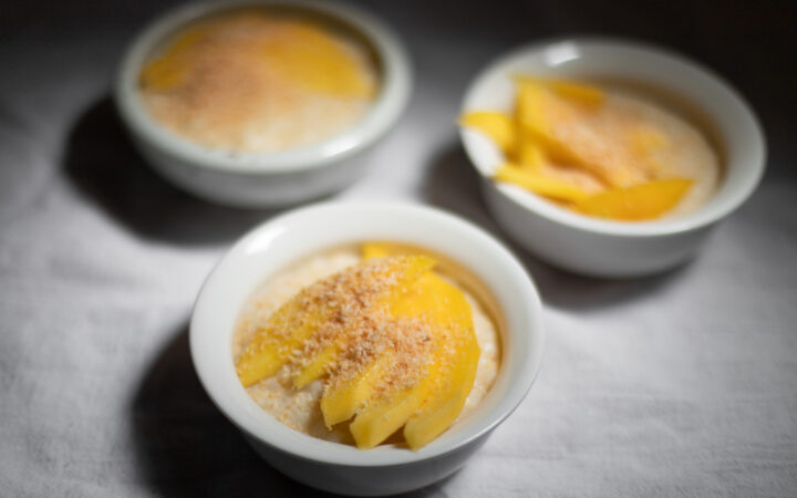 coconut rice pudding with mango and coconut flakes