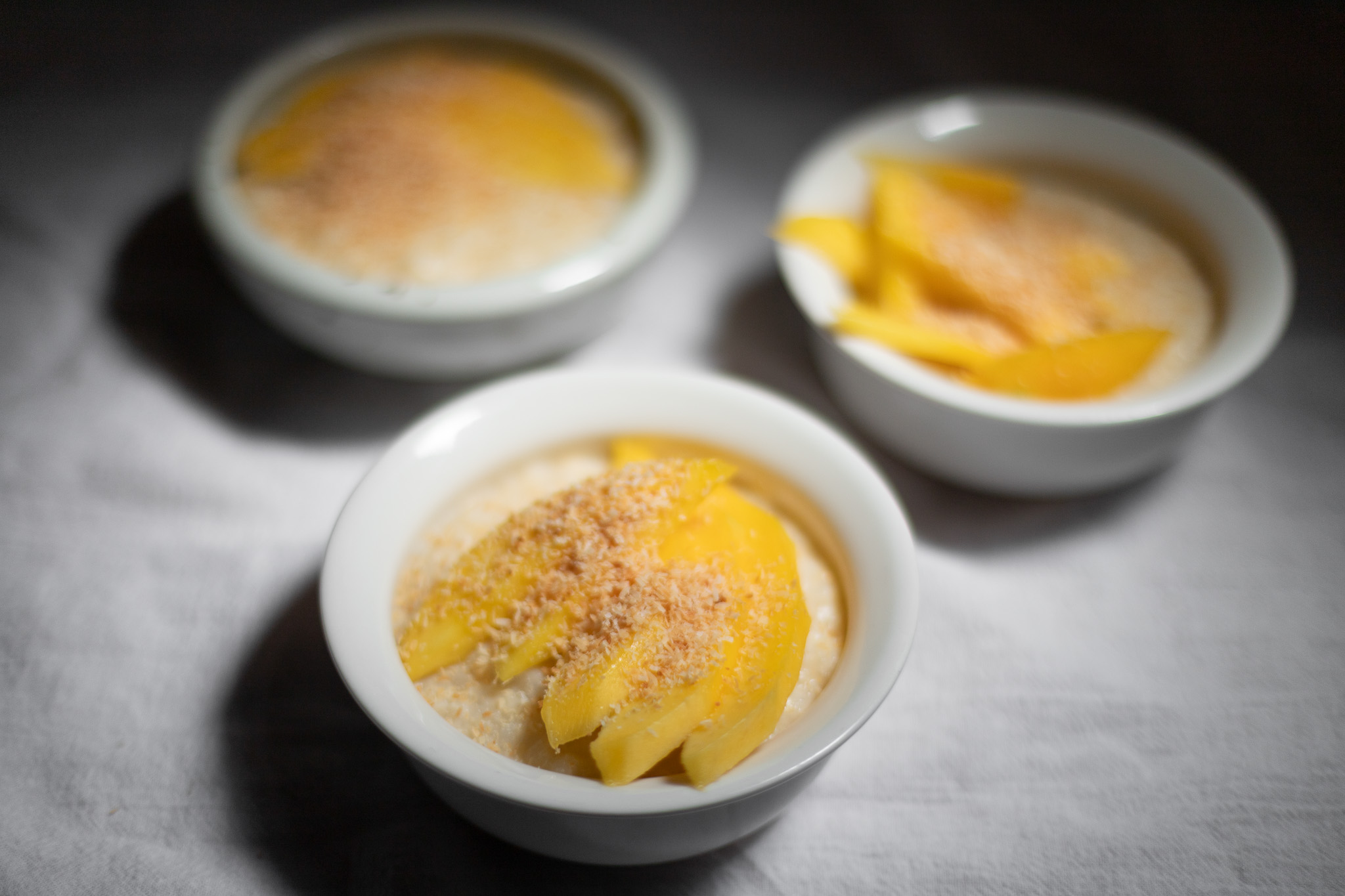 coconut rice pudding with mango and coconut flakes