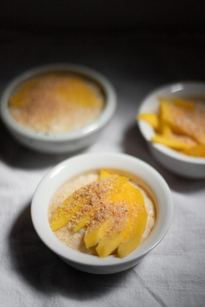 coconut rice pudding with mango and coconut flakes