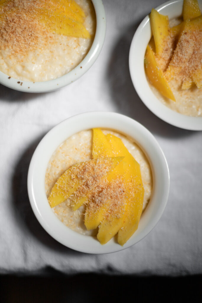 coconut rice pudding with mango and coconut flakes