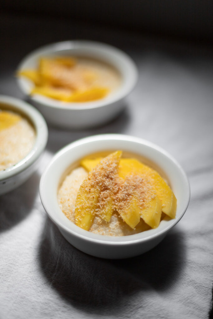 coconut rice pudding with mango and coconut flakes
