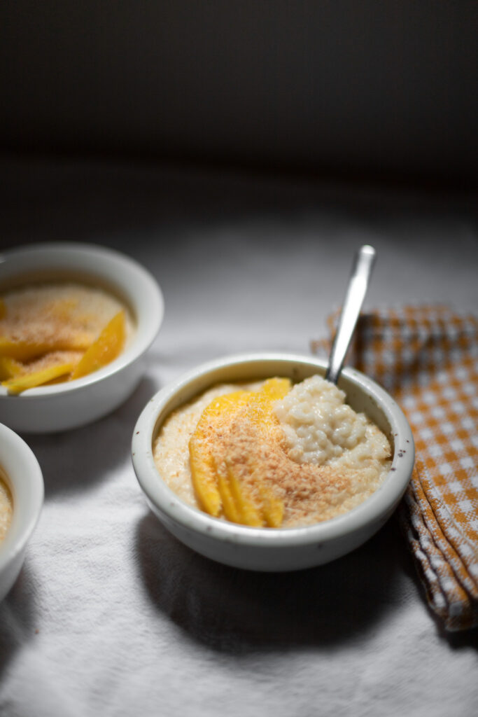 coconut rice pudding with mango and coconut flakes