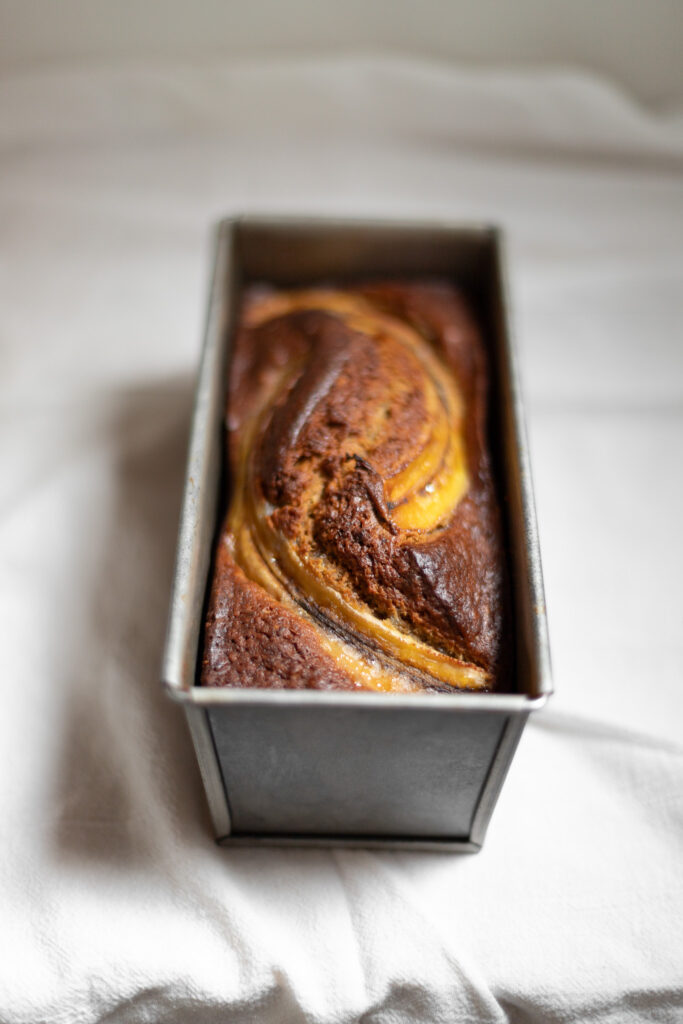 a loaf of brown butter banana bread in the pan