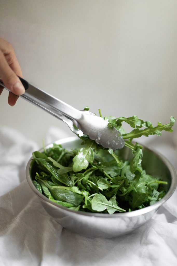 green salad being tossed